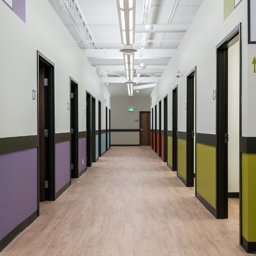Treatment room hallway with color-coded doors inside the Waterloo clinic